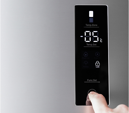 Un doigt appuie sur l'écran tactile noir d'un réfrigérateur affichant une température de -18°C.